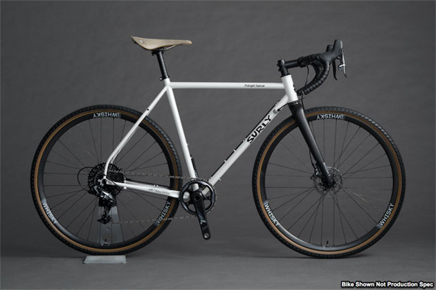 Right profile view of a Surly Midnight Special bike, white, with Whisky forks, against a gray background